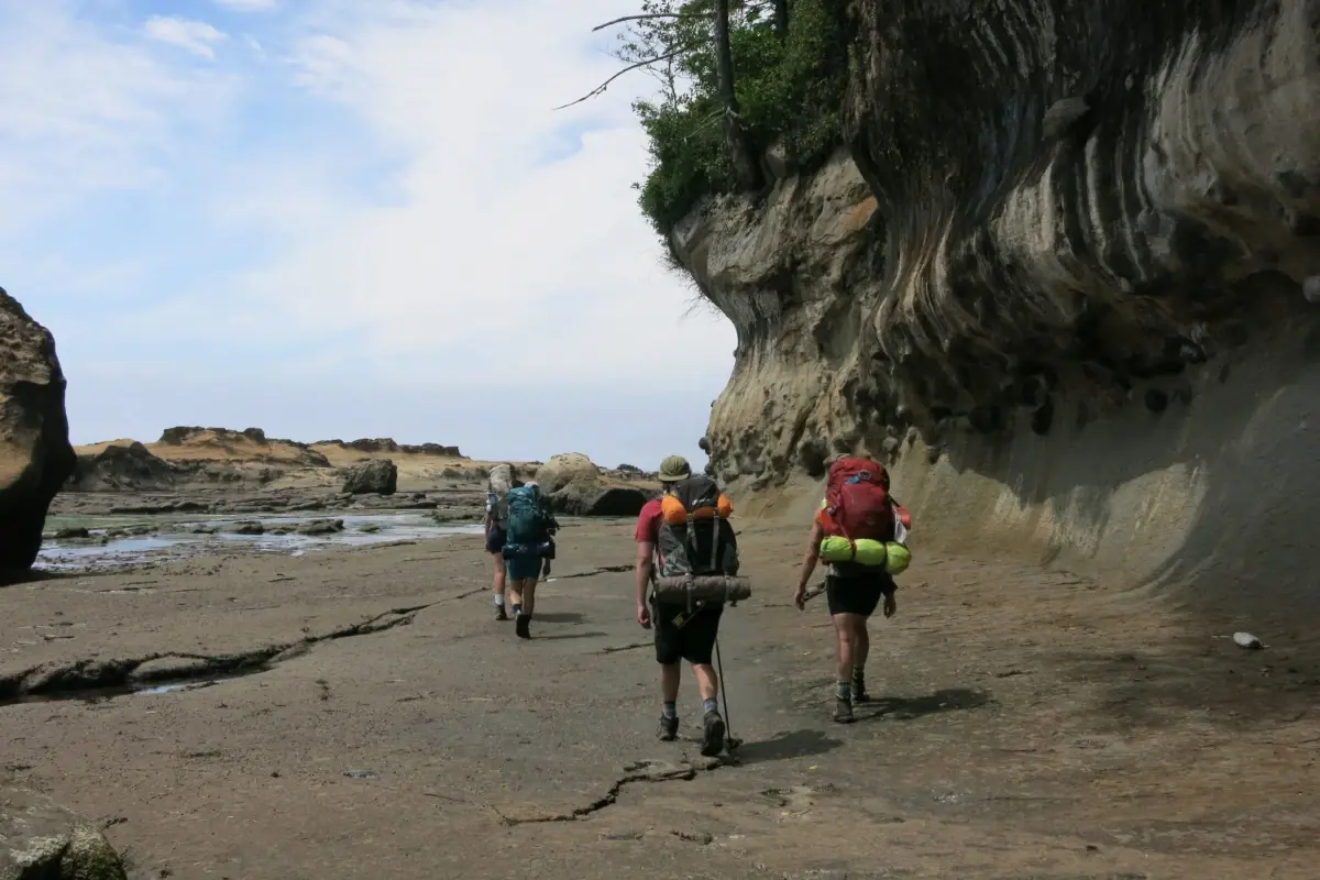 Backpackers trek along a sandstone shelf on the West Coast Trail.