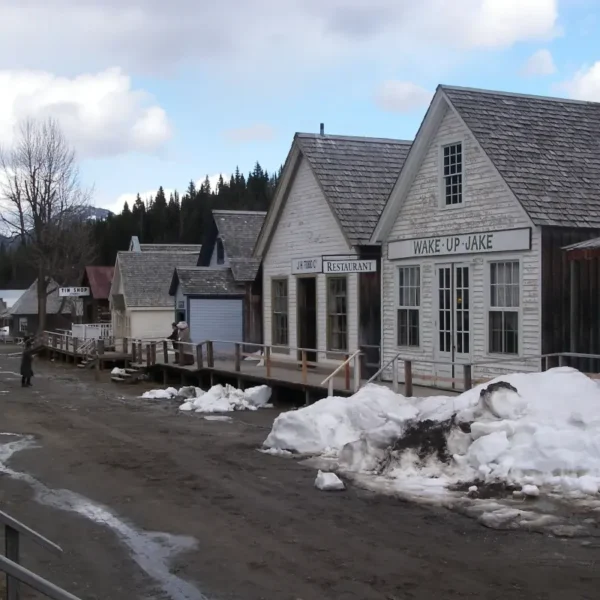 The ghost town of Barkerville is seen with piles of snow on the street.