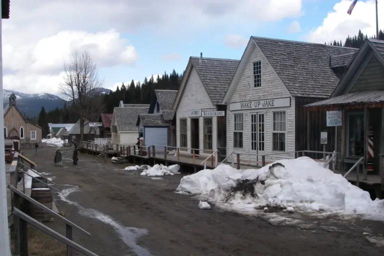 The ghost town of Barkerville is seen with piles of snow on the street.