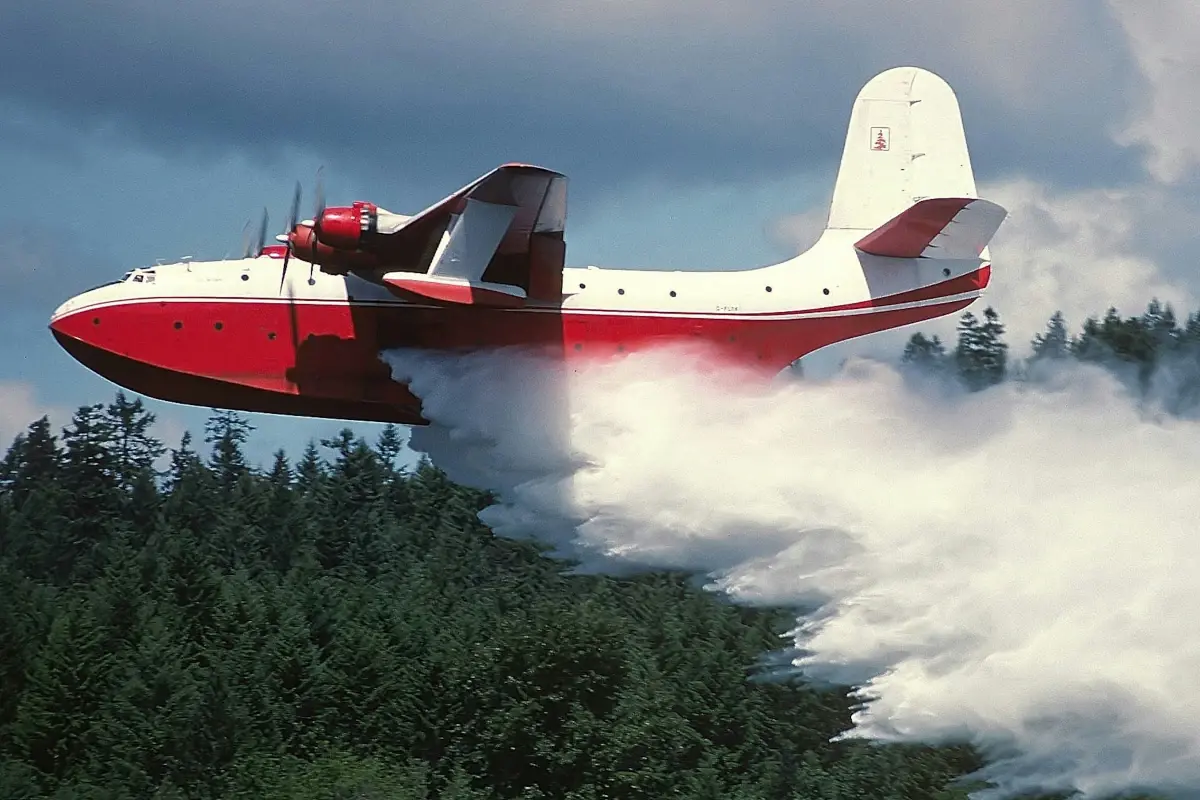 A Martin Mars water bomber releases water.