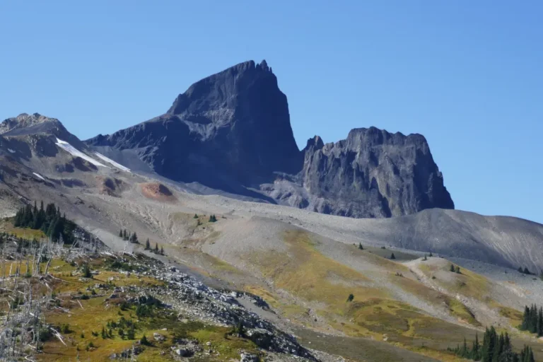 Craggy black tusk peak pierces the blue sky