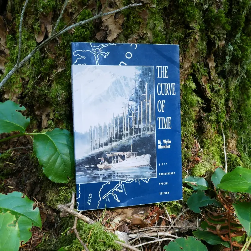 "The Curve of Time" by M. Wylie Blanchett is propped against a tree.