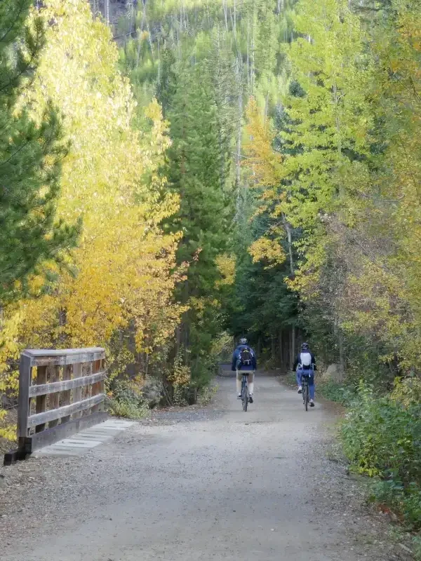 Two people enjoy biking on the Kettle Valley Rail Trail at Myra Canyon.