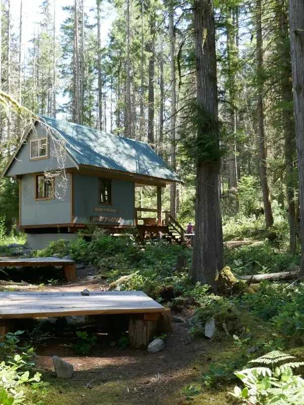 The Bliss Portage hut neatled in the woods on the Sunshine Coast Trail.