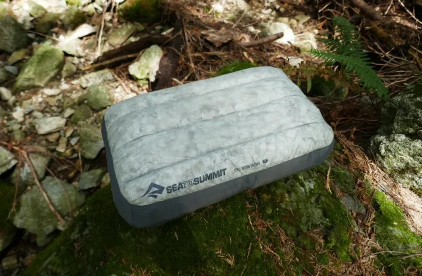 An Aeros Down pillow sits on a rock.