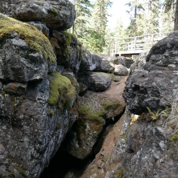 A cave is seen below a view platform at the Bridge Lake Ice Caves.