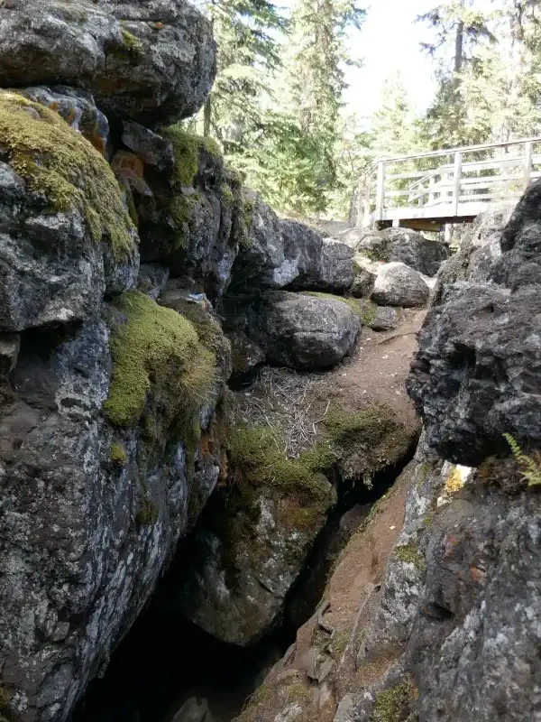 A cave is seen below a view platform at the Bridge Lake Ice Caves.