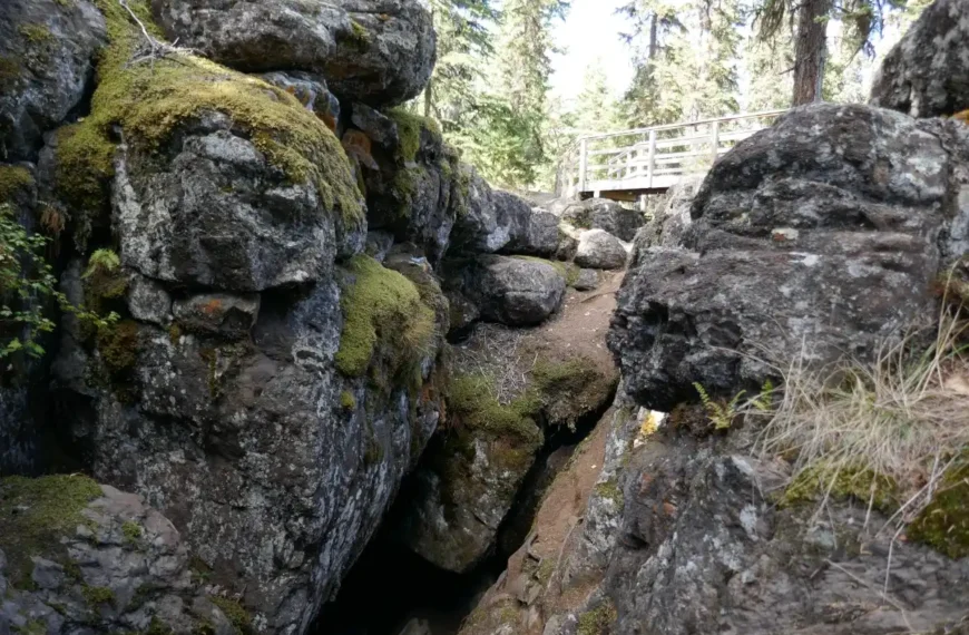A cave is seen below a view platform at the Bridge Lake Ice Caves.